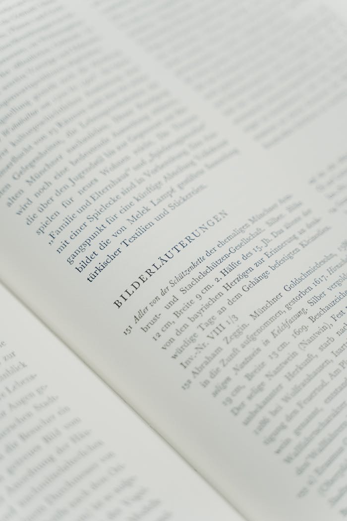 Close-up of an open book page with text in focus, emphasizing literature and reading concept.